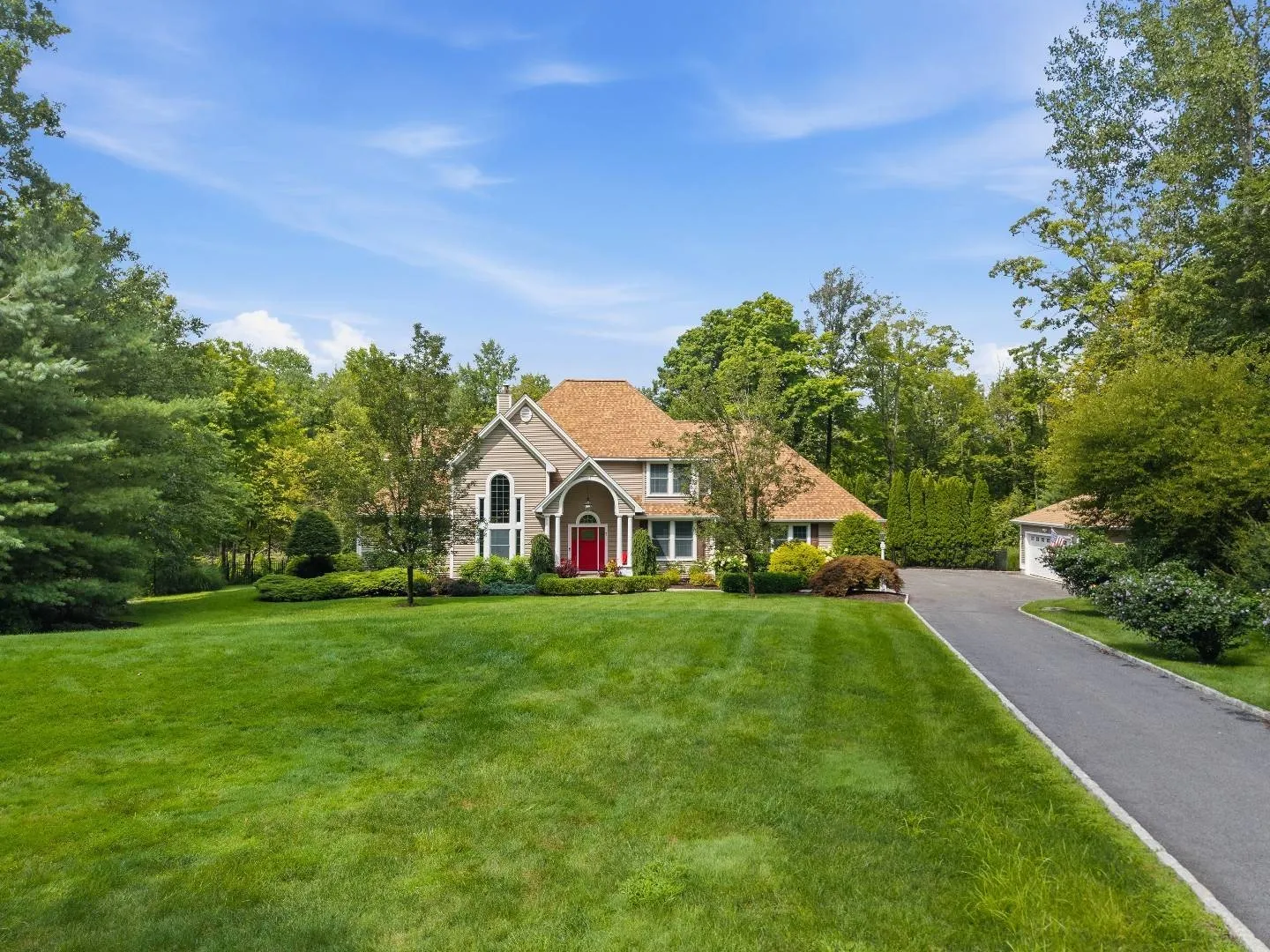 A welcoming Connecticut home surrounded by mature trees and lawn